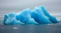 Vibrant Blue Iceberg Floating in Cold Polar Sea Royalty Free Stock Photo