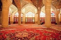 Impressive interior of Nasir ol Molk Mosque and resting people inside