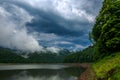 Impressive landscape of green coniferous mountains above lake against the background of stormy gray clouds, rainy weather, Ukraine Royalty Free Stock Photo