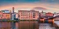 Impressive medieval arched St Trinity bridge Ponte Santa Trinita over Arno river. Amazing summer sunset on Florence, Italy, Euro Royalty Free Stock Photo