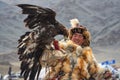 Bayan-Ulgii, Mongolia - October 01, 2017: Impressive Mongolian Hunter In Traditional Clothes Of Fox Fur With A Golden Eagle On Han Royalty Free Stock Photo