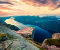 Impressive morning view of popular Norwegian attraction Preikestolen. Great summer sunrise of the Lysefjorden fjord, located in Royalty Free Stock Photo