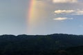 Rainbow with blue sky and mountain range