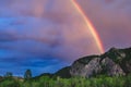 An impressive rainbow over a mountain range in Kuray steppe of Altai Krai