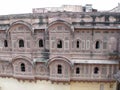 Impressive reddish-toned facade of the Mehrangarh Fort in the blue city of Jodhpur, India