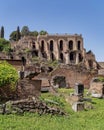Impressive ruins of Domus Tiberiana in the Roman forum under clear blue sky.
