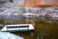 Impressive sandstone wall on the bank of Salacas river and Tourism raft with seats, Skanaiskalna National Park, Latvia