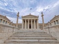 Stairway leading to the national academy of Athens neoclassical building with Athena and Apollo statues.