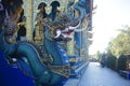 Impressive statue of Naga snake, a mythical serpent-like creature, guarding Wat Rong Suea Ten or Blue Temple. Chiang Mai