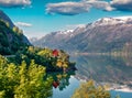 Impressive summer view of red painted house on the shore of Hardangerfjord fjord, Hordaland county, Norway. Beauty of countryside Royalty Free Stock Photo