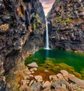 Impressive sunrise on waterfall in the outskirts of Haldarsvik village. Exciting summer scene of Streymoy island, Faroe, Denmark,