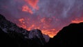 Impressive sunset over snow-capped mountain range in the Himalayas near Thame, Nepal with dramatic orange and purple sky. Royalty Free Stock Photo