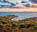 Impressive sunset view of Piscinni bay with Torre di Pixinni tower on background. Fantastic evening scene of Sardinia island, Ital