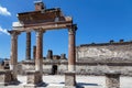 Impressive temple ruins at the archaeological site of Pompeii against a bright blue sky. Pompeii, Campania, Italy
