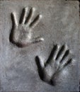 Imprint of mans and womans hand in mortar