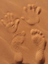 An imprint of our hands and feet in the sand Royalty Free Stock Photo