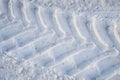 The imprint of wheels big tractor in snow Royalty Free Stock Photo