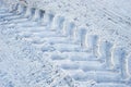 The imprint of wheels big tractor in snow Royalty Free Stock Photo