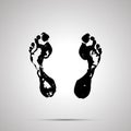 Imprints of bare human foots, simple black icon with shadow on gray