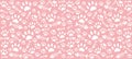 Imprints of cat`s paws and skeletons of white fish on a pink background.