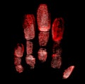 Imprints of the left hand on black background, red color