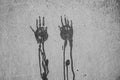 Imprints of two wet dripping hands on a wall in black and white. Royalty Free Stock Photo