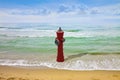 An improbable hydrant at the seaside - Plenty of water illogical concept image Royalty Free Stock Photo