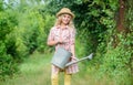 Improve irrigation timing. Optimize water use. Watering plants in garden. Girl child hold watering can. Spring gardening Royalty Free Stock Photo