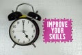 Improve Your Skills text with alarm clock on pink background Royalty Free Stock Photo