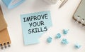 Improve your skills word on office table with computer, coffee, notepad, smartphone and digital tablet Royalty Free Stock Photo