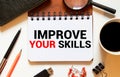 Improve your skills word on office table with computer, coffee, notepad, smartphone and digital tablet Royalty Free Stock Photo