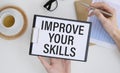 Improve your skills word on office table with computer, coffee, notepad, smartphone. Royalty Free Stock Photo