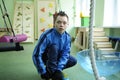 Improving motor control: Down syndrome boy doing exercises at the rehabilitation room