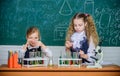 Improving their study skills. Study group in chemistry laboratory. Little school children holding test tubes during