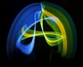 Improvisation by light by multicolored lines, blue-yellow-green lines like a tape Royalty Free Stock Photo