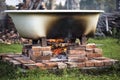 Improvised hot bathtub with fire underneath. Royalty Free Stock Photo