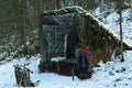 Improvised lean-to shelter in the winter forest