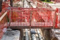 Improvised wooden bridge over the trench with new district heating pipeline system installations on the street construction site f