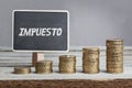 Impuesto, Spanish text for Tax on board, growing stacks of money