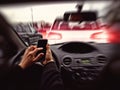 Inattentive driver looks at the phone while driving Royalty Free Stock Photo