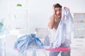 The inattentive husband burning clothing while ironing Royalty Free Stock Photo