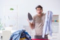 The inattentive husband burning clothing while ironing Royalty Free Stock Photo