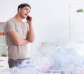 Inattentive husband burning clothing while ironing Royalty Free Stock Photo