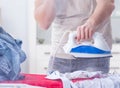 Inattentive husband burning clothing while ironing Royalty Free Stock Photo
