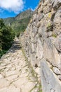 Inca trail paved with stones at Machu Picchu site in Peru. Royalty Free Stock Photo