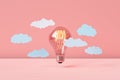 Incandescence lighted bulb with cloud on pink background Royalty Free Stock Photo