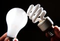 Incandescent and cfl lightbulb on black