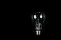 Incandescent light bulb on a black background