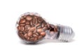 Incandescent light bulb with coffee beans on white Royalty Free Stock Photo