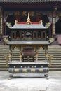 A incense burner in front of temple